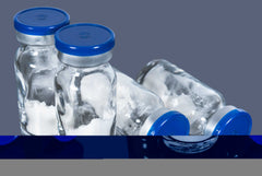 Clear glass vials with blue caps containing white custom GLP-1 peptide powder for pharmaceutical use