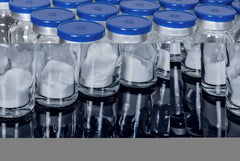Rows of glass vials with blue caps containing dulaglutide powder for private label pharmaceutical use