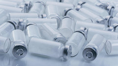 Clear plastic vials of Ipamorelin with CJC-1295 peptide for growth hormone release, 1-gram size