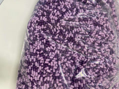 Large bag of purple and lavender capsules of Naproxen Sodium or Ibuprofen combined with Omeprazole for stomach protection