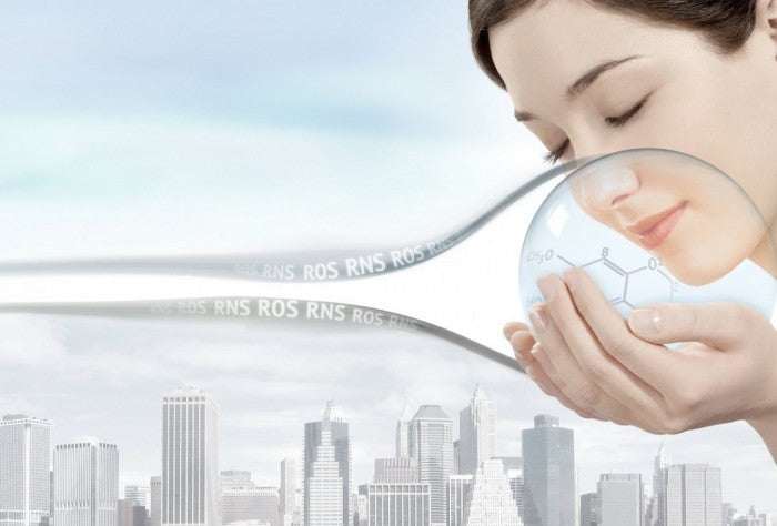 woman smelling clear skincare product in lab setting for Triple Strength Intensive Bleaching Cleanser